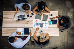 Team members collaborating at the desk