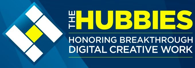 Eine blaue Grafik mit einem weiß-gelben Rautenlogo auf der linken Seite. Rechts steht in fetter gelber Schrift „THE HUBBIES“ über kleinerem weißem Text: „Honoring Breakthrough Digital Creative Work.“