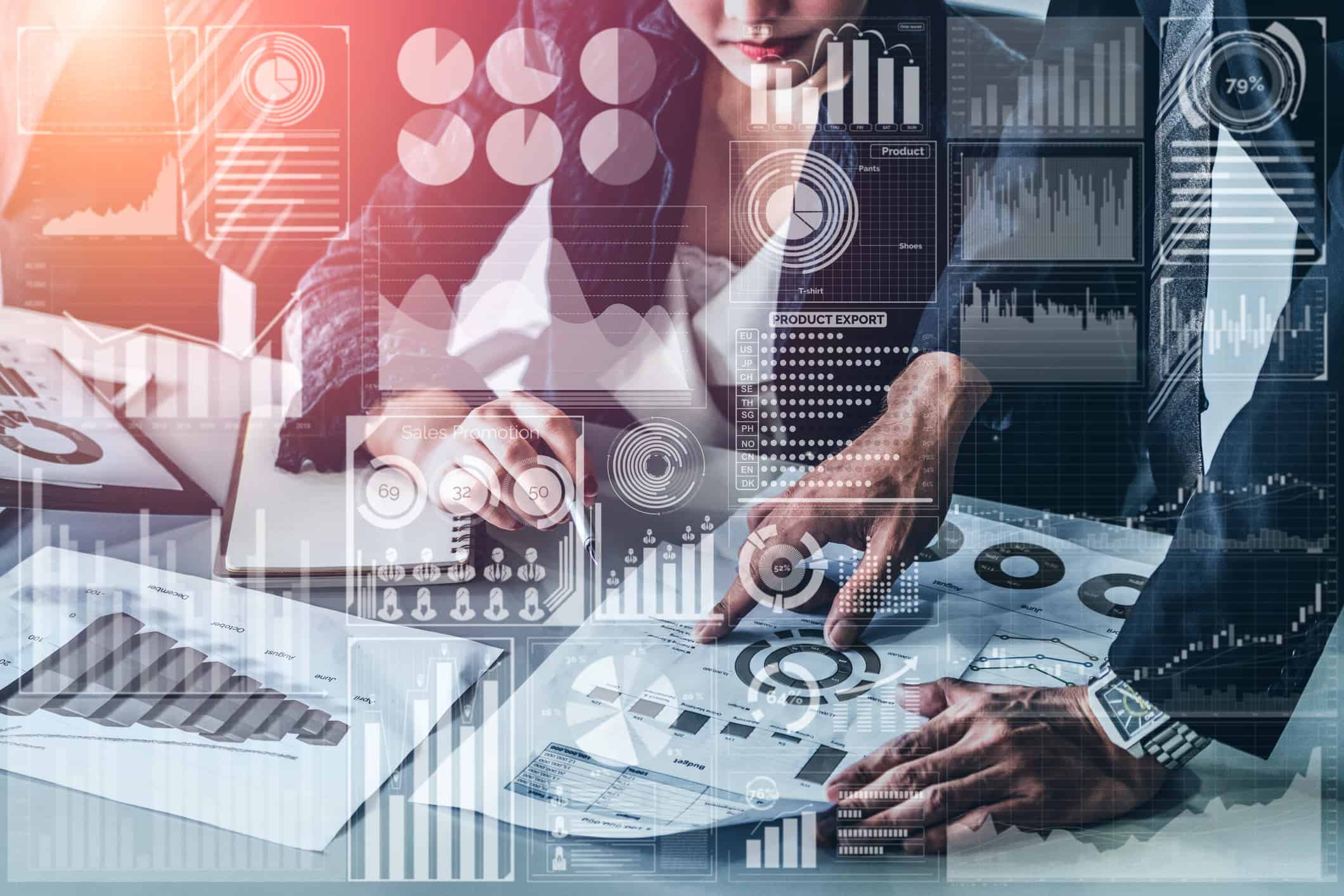 Two people analyze printed charts and graphs on a desk, with digital data visualizations and infographics overlaid, suggesting teamwork in media budget forecasting or business strategy planning.