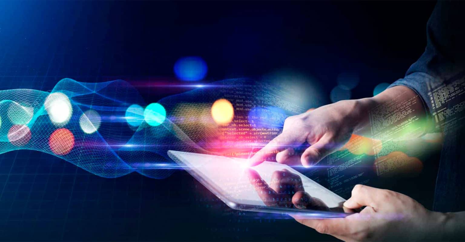 A person uses a touchscreen tablet, with one hand holding it and the other touching the screen. Colorful digital light effects, data streams, and code overlays evoke technology and connectivity—perfect for demonstrating Instacart Advertising software.