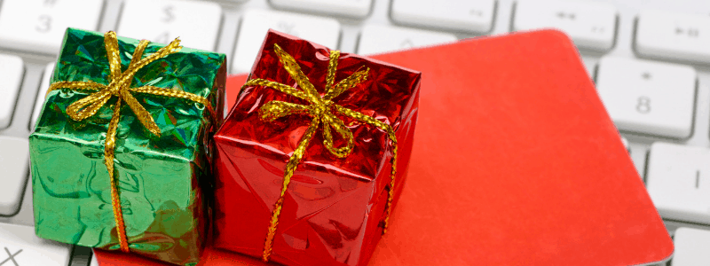 Small Christmas gifts laying on top of a keyboard