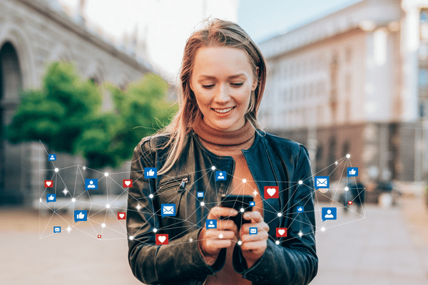 Woman on her phone utilizing multiples social channels