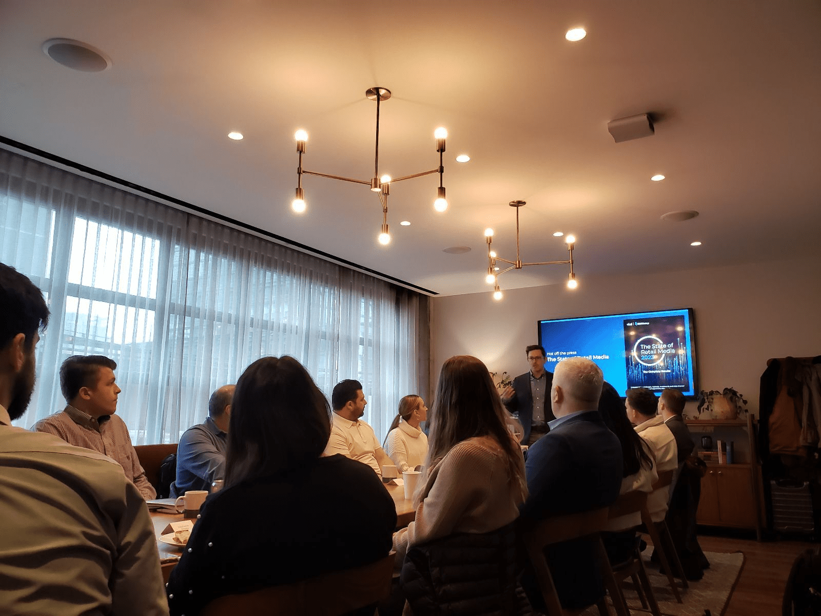 Attendees watching a presentation of Skai State of Retail Media