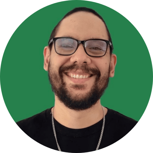 A smiling man with a beard and glasses, wearing a black shirt and silver chain necklace, is pictured against a solid green circular background—perfect for illustrating a Search Term Analysis case study.