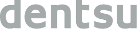 L'image montre le mot « dentsu » écrit en minuscules, en gras et en gris clair sur un fond blanc.