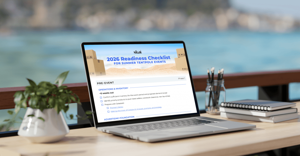 A laptop on an outdoor table displays a 2026 Readiness Checklist for Summer Tentpole Events webpage from the summer sales hub. Nearby are a spiral notebook, pen, and glass of water. The background shows a blurred seaside view.