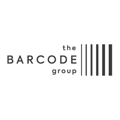 Logo comportant le texte « the BARCODE group » à côté de barres noires verticales rappelant un code-barres, le tout sur un fond circulaire blanc — une identité inspirée des enseignements tirés de notre étude de cas OMRON Amazon Ads.